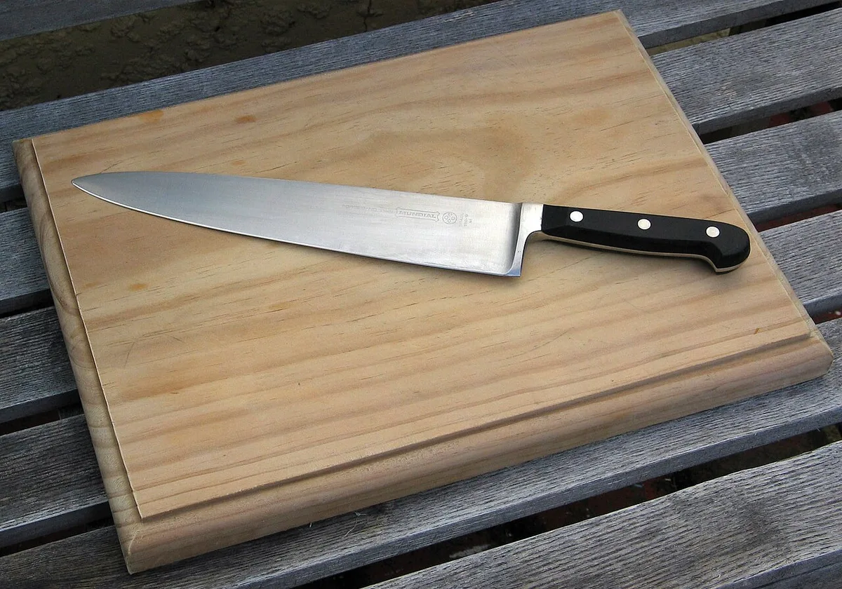 Wooden cutting board with a chef’s knife